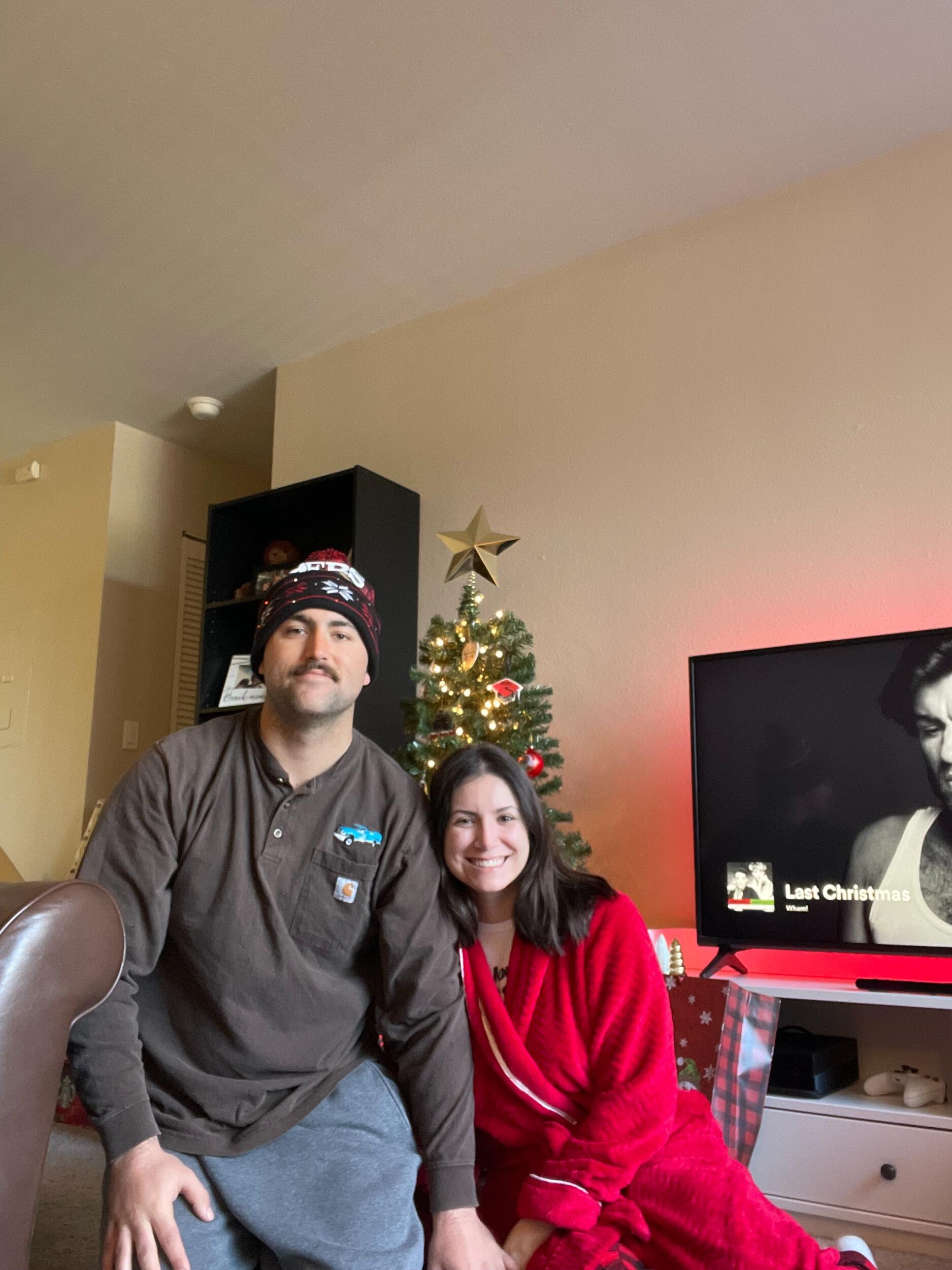Rachel and John's first Christmas morning opening presents together in their apartment. 