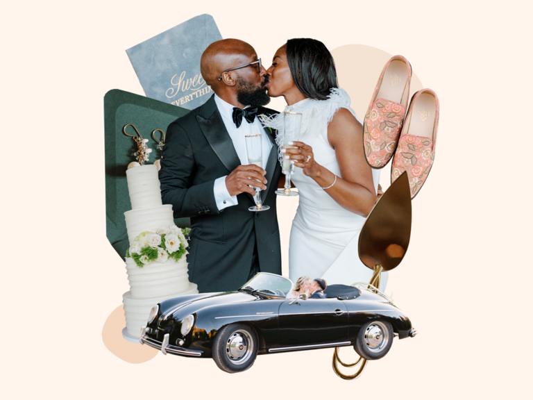 Couple kissing holding champagne glasses surrounded by classic romantic wedding theme decor