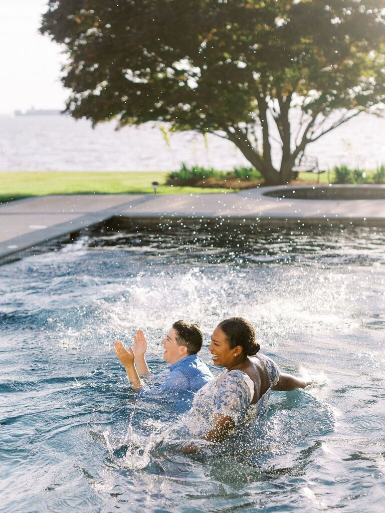 Couple in pool wearing formalwear fun summer engagement photo idea