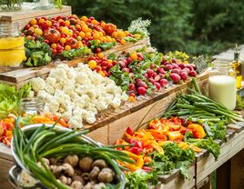 Table full of raw fruit and vegetables