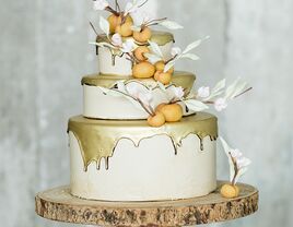 Metallic gold drip wedding cake with fondant peaches