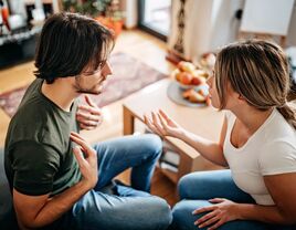 Couple sitting on a couch having an argument