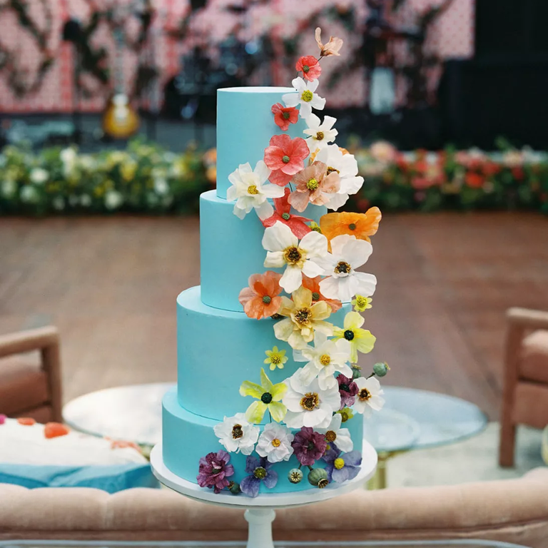 Whimsical light blue wedding cake with flowers