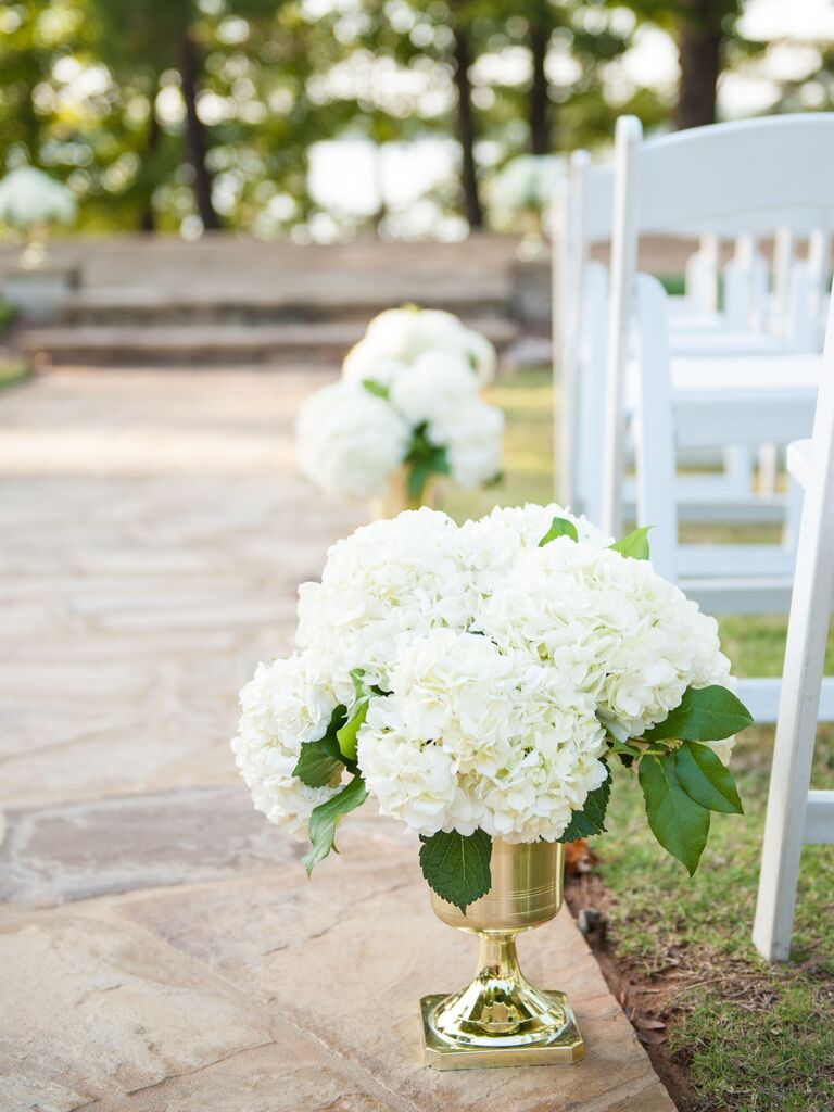 classic aisle markers for wedding with white hydrangeas in gold urn vases