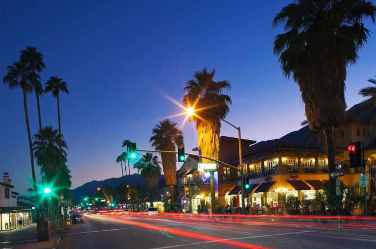 Palm Springs Bachelorette Party Nightlife - Restaurants and shops along N Palm Canyon Drive at dusk.
