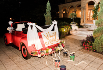 Vintage wedding car with just married sign and paint cans