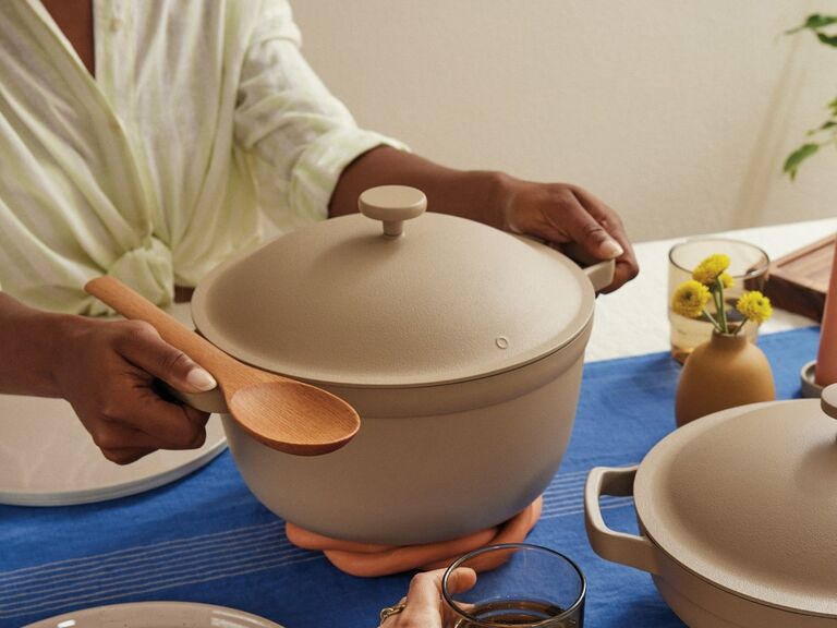 Woman holding Our Place Perfect Pot with lid on in neutral colorway useful wedding gift idea