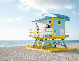 Miami south beach, couple by lifeguard hut during Sunrise Miami Beach