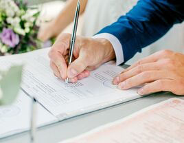 man signing marriage license