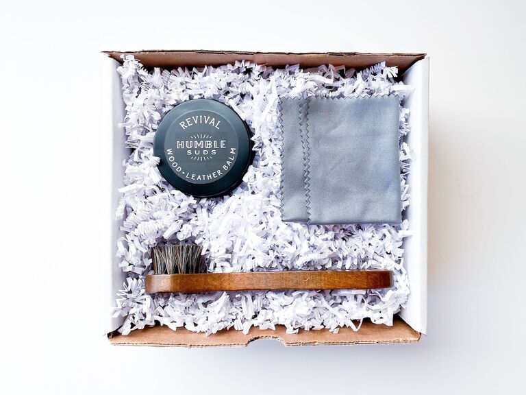 A shoe shining kit with a cloth, brush and wood-leather balm from Etsy