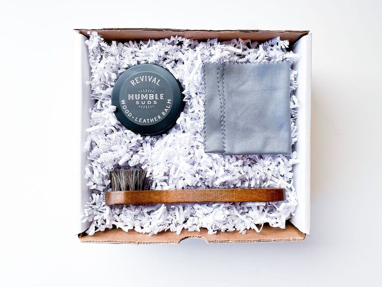 A shoe shining kit with a cloth, brush and wood-leather balm from Etsy