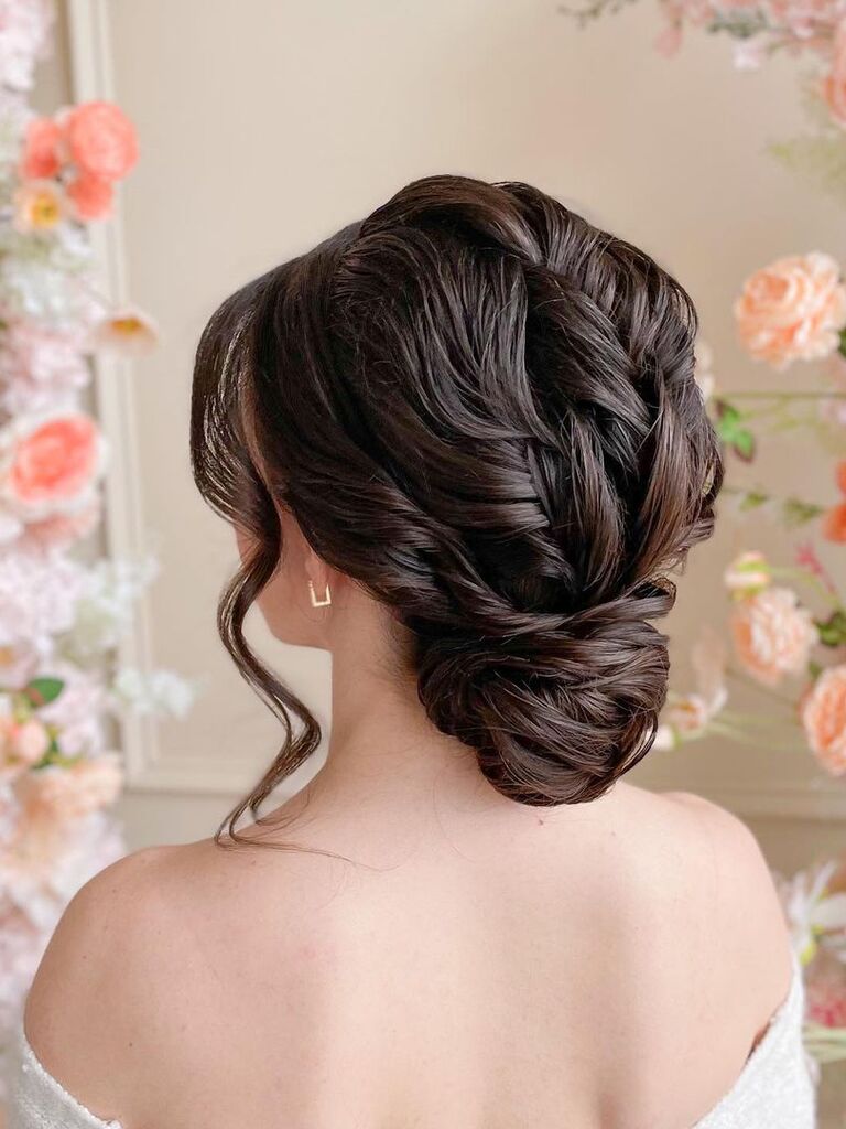 Romantic textured low bun wedding updo for long hair
