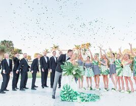 bride, groom and wedding party tossing confetti at tropical wedding