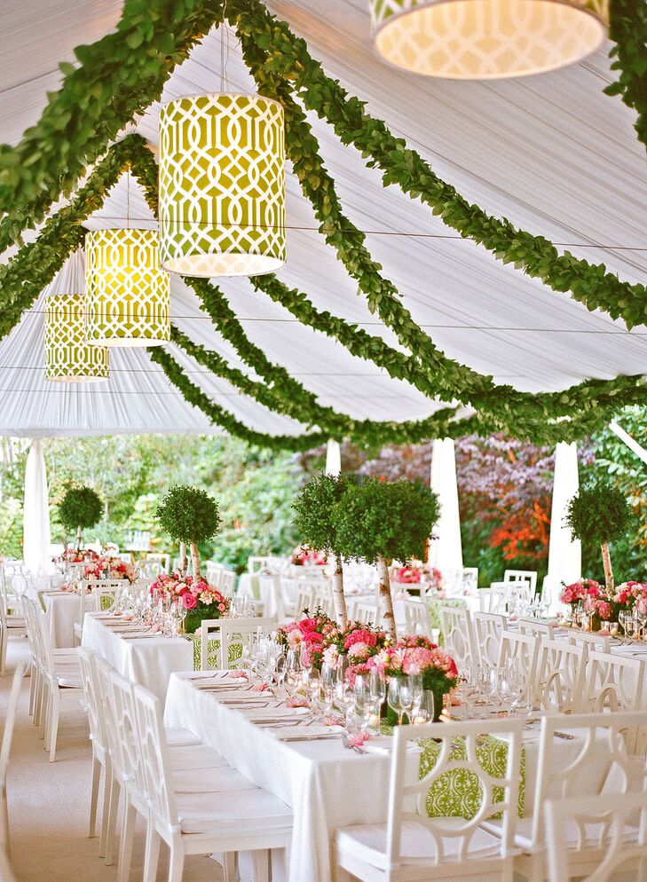 Tented wedding reception with green garland accents