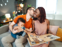 Husband and wife sitting on couch with child
