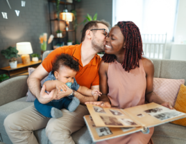 Husband and wife sitting on couch with child