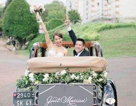 Couple in decorated getaway car