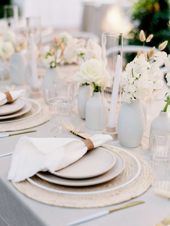 White-and-gray tables cape with bud vase arrangements