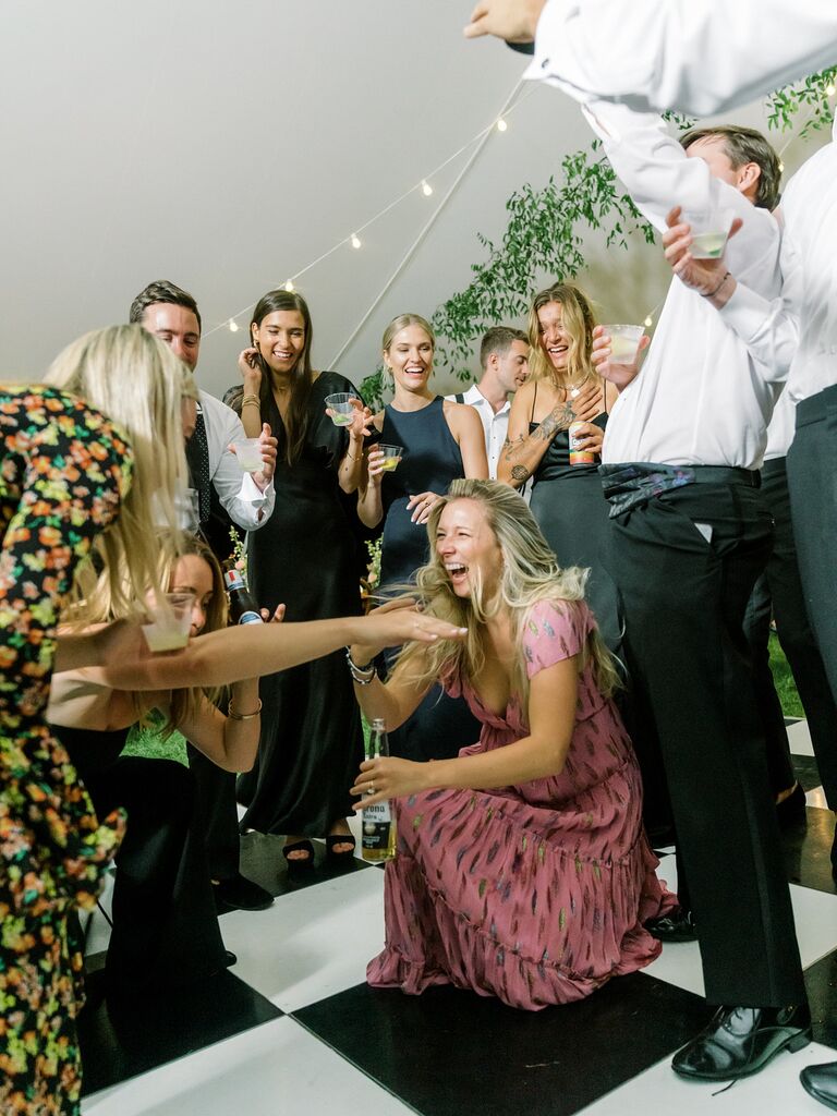 Wedding guests dancing and laughing at reception