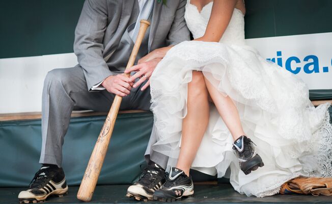 Bride and groom wearing baseball cleats