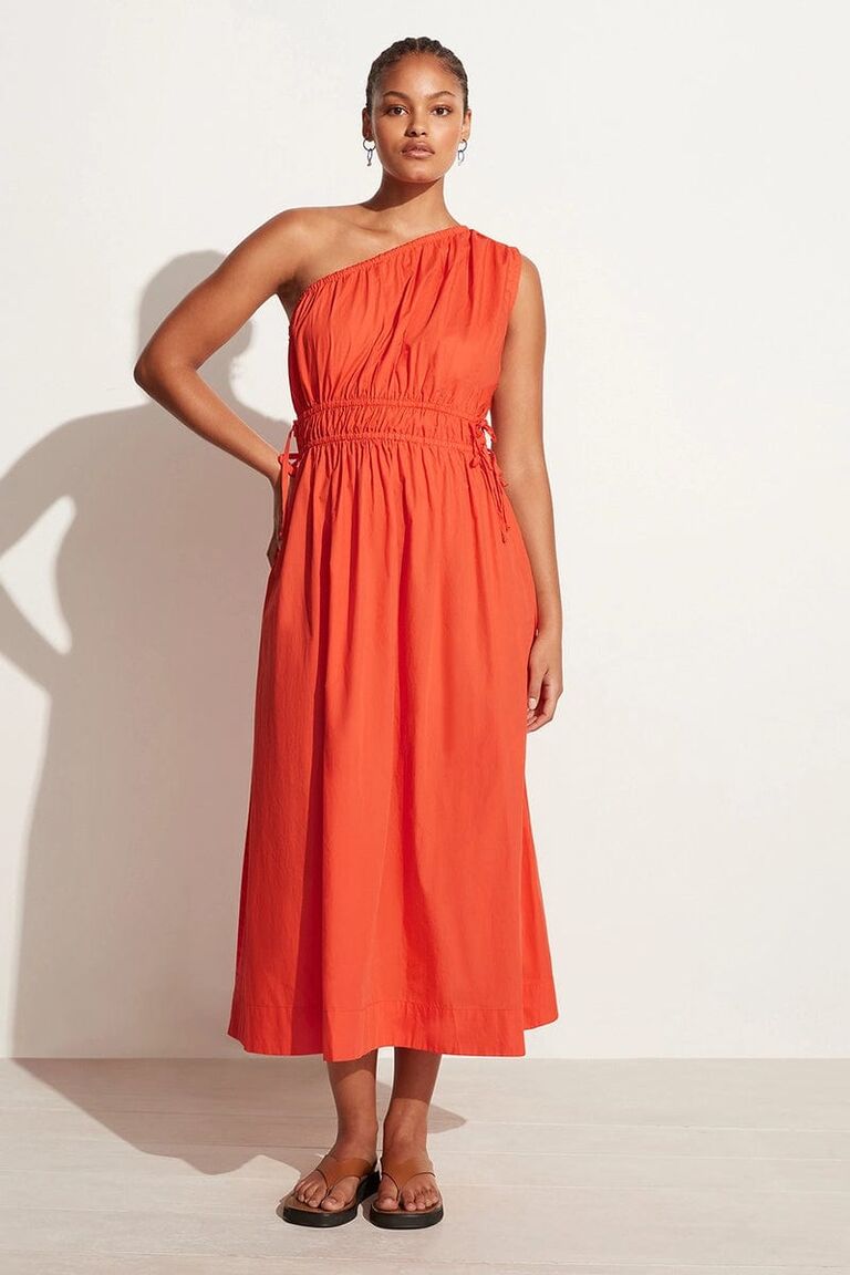 Orange one-shoulder dress for a beach wedding by Faithfull The Brand. 