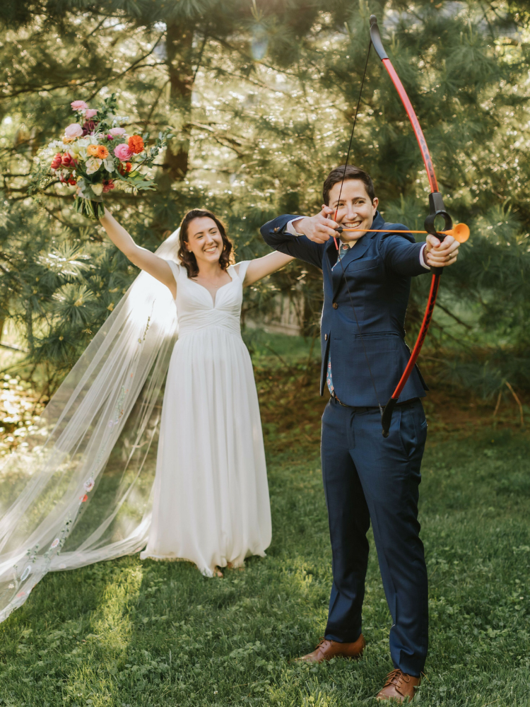 Couple doing archery during backyard wedding