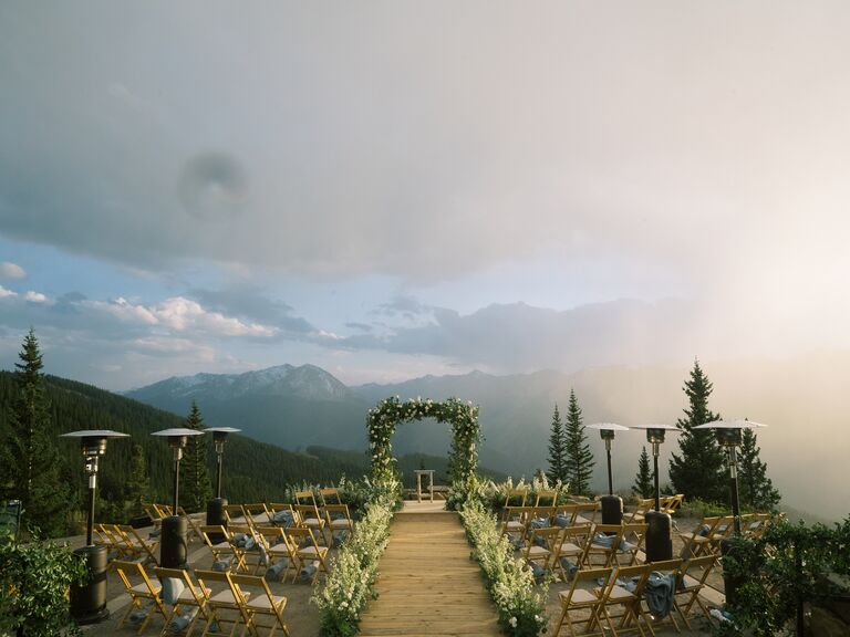 Venue: The Little Nell wedding deck on a misty day with clouds and sun beaming through
