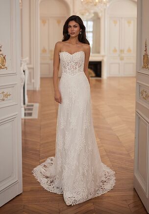 The Moonlight Collection J7001 wedding dress is a timeless fit-and-flare gown in re-embroidered lace, featuring a strapless illusion sweetheart neckline, open back, and a sculpting basque waist for a flattering, body-hugging silhouette. Finished with a flowing fishtail skirt, eyelash lace detailing, and a scalloped chapel train, this ivory design blends classic romance with elegant structure.