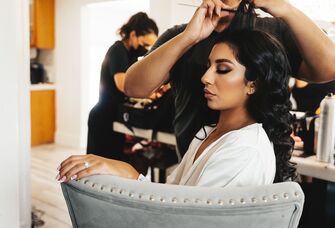 Bride enjoying getting her hair styled for her big day