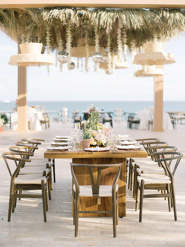 outdoor wedding reception with neutral decor and boho dried flowers