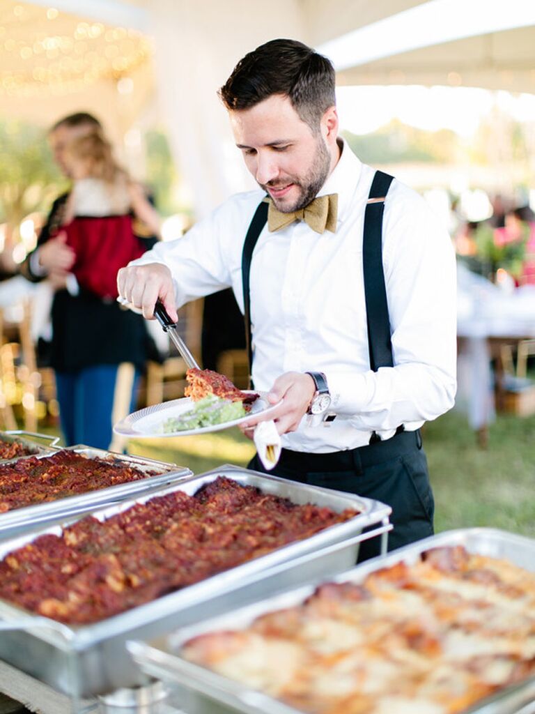 Wedding guest at self-serve barbecue food station at outdoor summer wedding