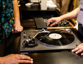 People standing at DJ booth at wedding reception