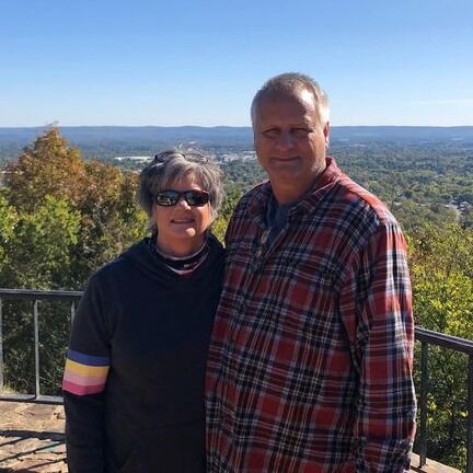 Kim and Tim Riggs In The Woods Owner