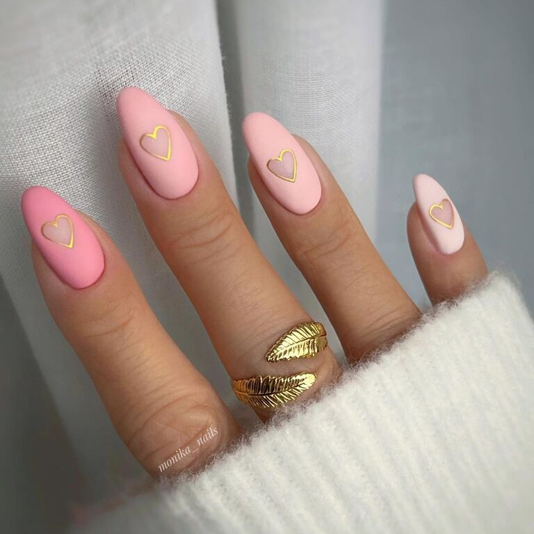 Matte pink Valentine's Day nails with gold hearts