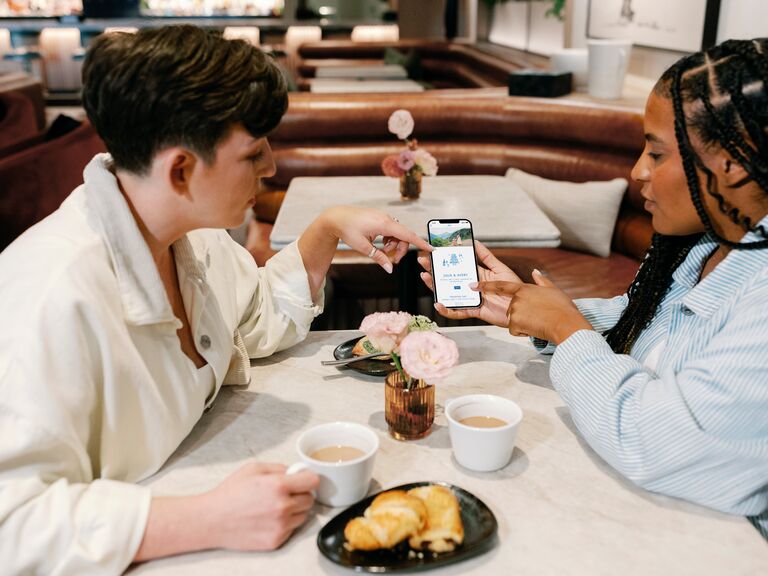 Woman showing her registry website in a cafe