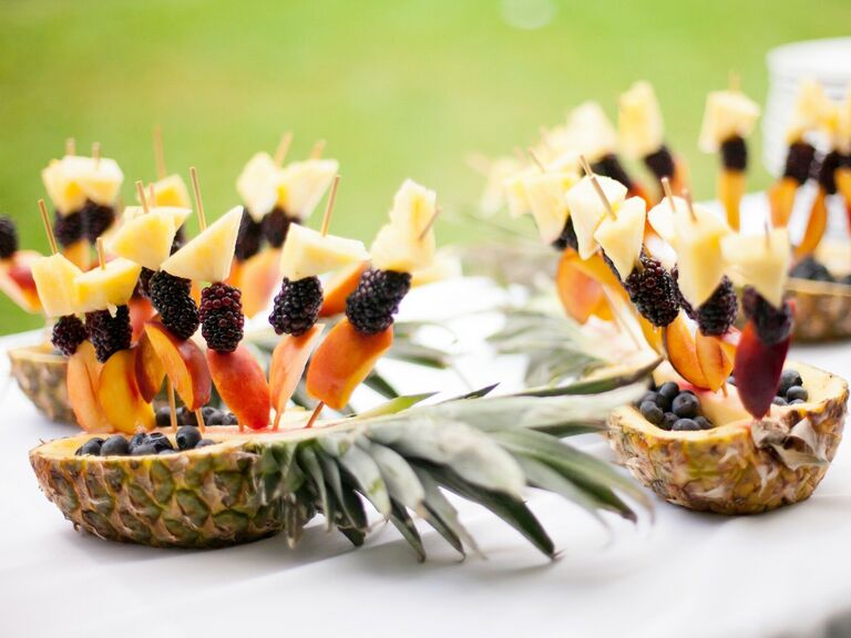 Refreshing fruit skewers in a pineapple boat for your outdoor wedding