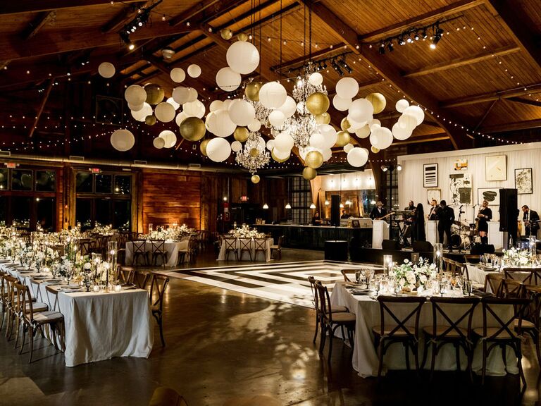 Rustic barn wedding venue with balloon installation on ceiling