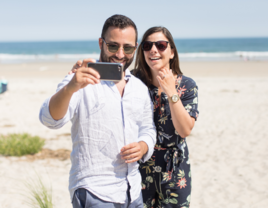 Couple taking selfie on beach in Maine after proposal