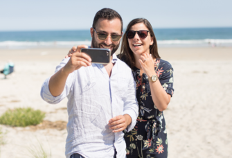 Couple taking selfie on beach in Maine after proposal