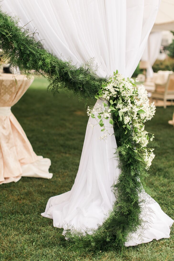 Green garland accenting a tented reception