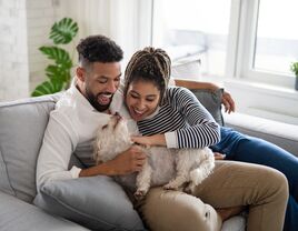 Young couple holding puppy