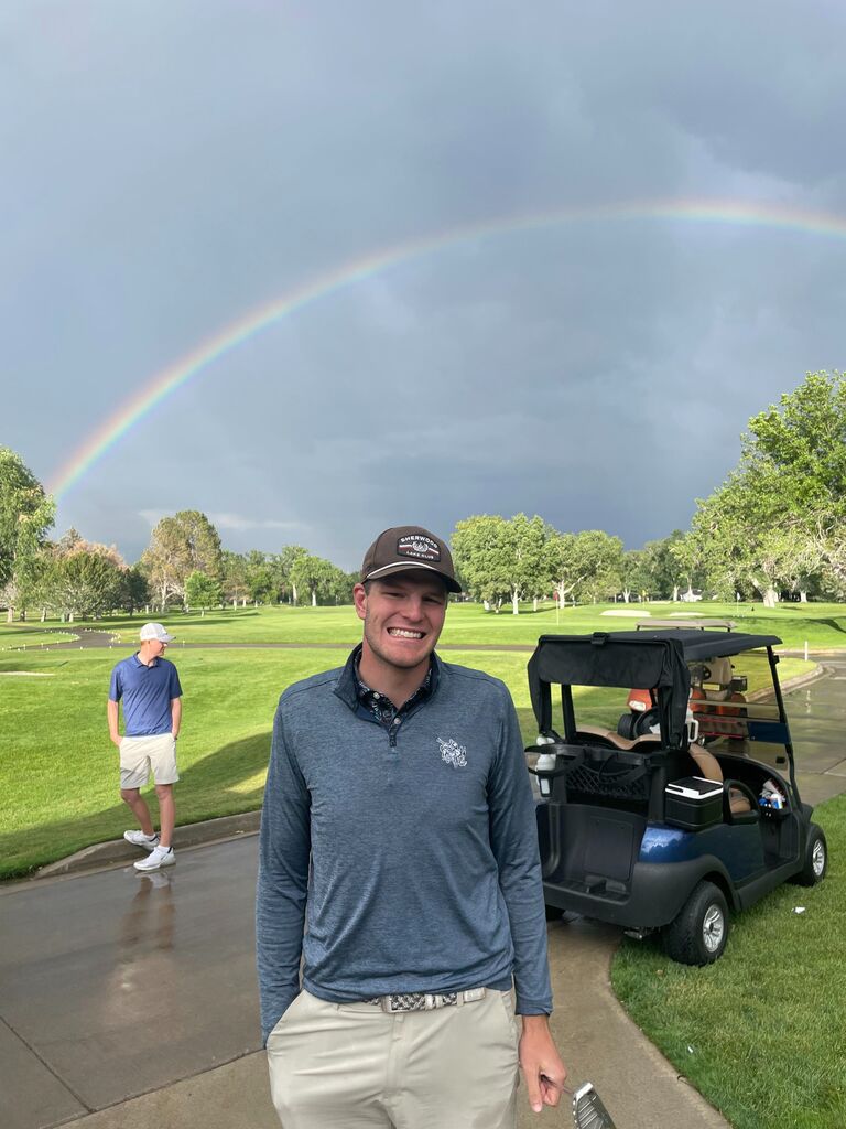 Megan went to watch Jake play in a tournament and forced him to smile underneath the rainbow