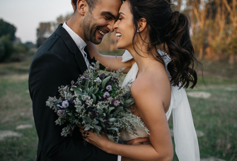 Bride and groom hugging and smiling, how to hyphenate last name