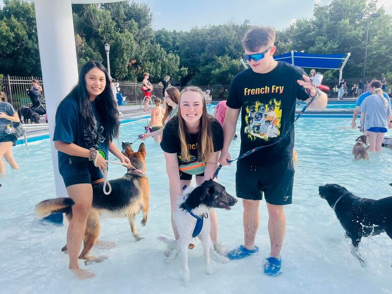 Proud pawrents Madeline and Evan taking French Fry for a swim at the Kansas Humane Society's Dog Days of Summer event.