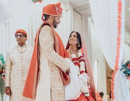 Wife looking up at her husband during cultural ceremony