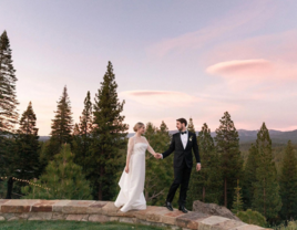 Bride and groom holding hands in sunset wedding portraits