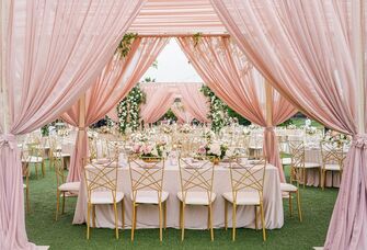 A lovely pink canopy over a wedding table setting.