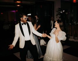 Bride and groom posing for direct flash photography at wedding reception