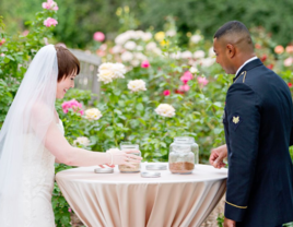 Bride and groom performing sand ceremony at wedding 