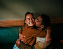 Couple hugging and kmissing on the cheek